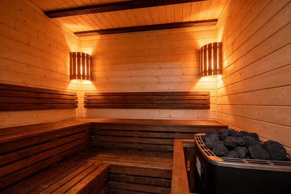 Dry sauna Dry sauna interior with wooden benches and electric heater